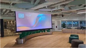 Townhall with a large projection screen and lounge seating