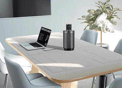 Compact meeting room with a laptop and a portable conferencing device