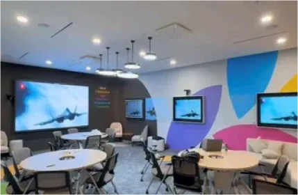 Training room with a video wall, round tables and wall displays, installed by VisionCast